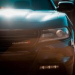 Close up of black and blue Dodge logo on a car