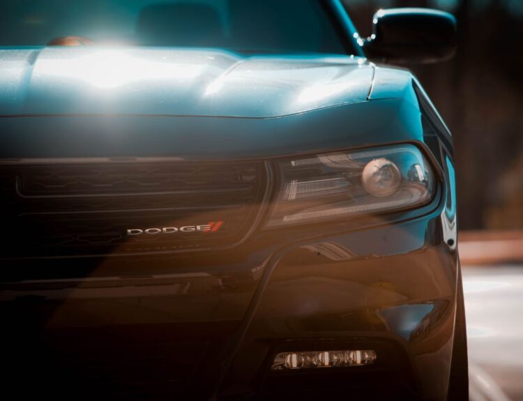 Close up of black and blue Dodge logo on a car