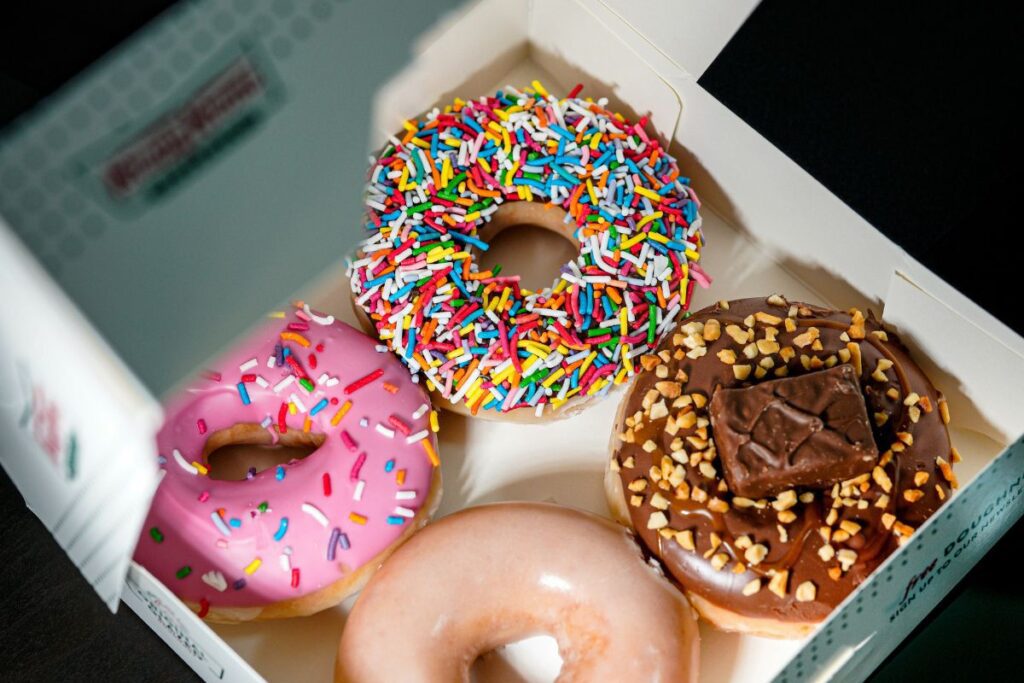 Who owns Krispy Kreme? Glazed and chocolate covered donuts with sprinkles