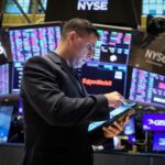 Wall Street indexes end higher, helped by Tesla, megacap growth stocks