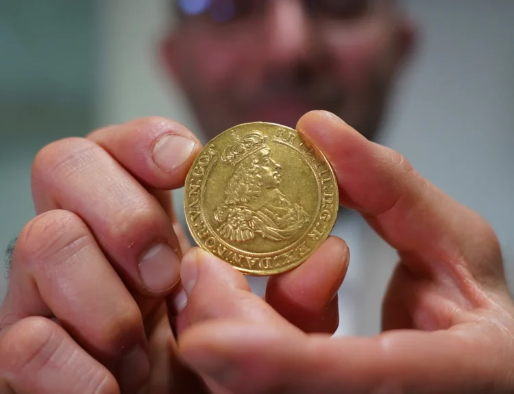 Vicken Yegparian the Vice President of Numismatics at Stacks Bowers Galleries holds a golden coin from the L E Bruun collection