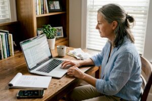 Woman updating finances in home office