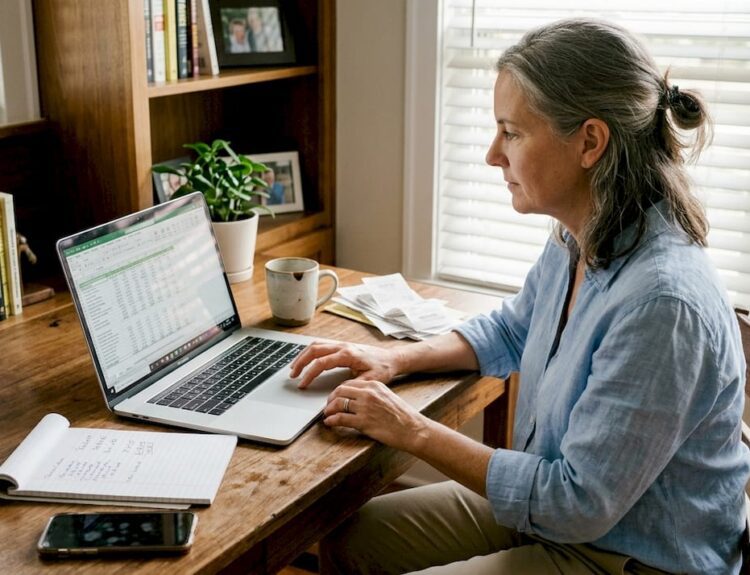 Woman updating finances in home office