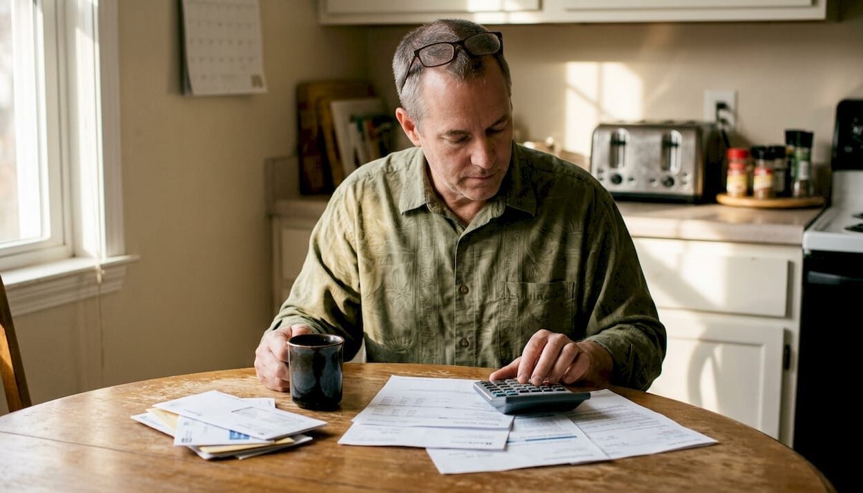 Man planning retirement at home kitchen table