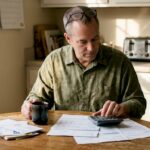 Man planning retirement at home kitchen table