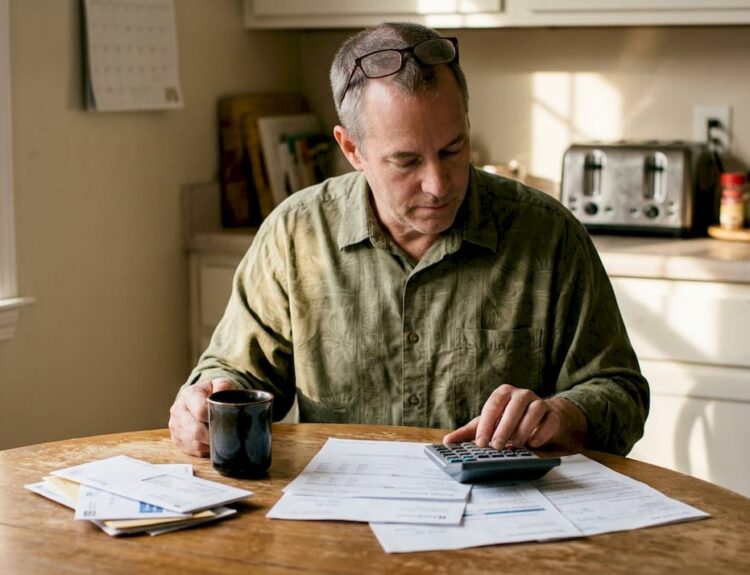 Man planning retirement at home kitchen table