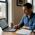 Man reviewing investments at kitchen table