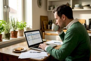 Man working on finances at kitchen table