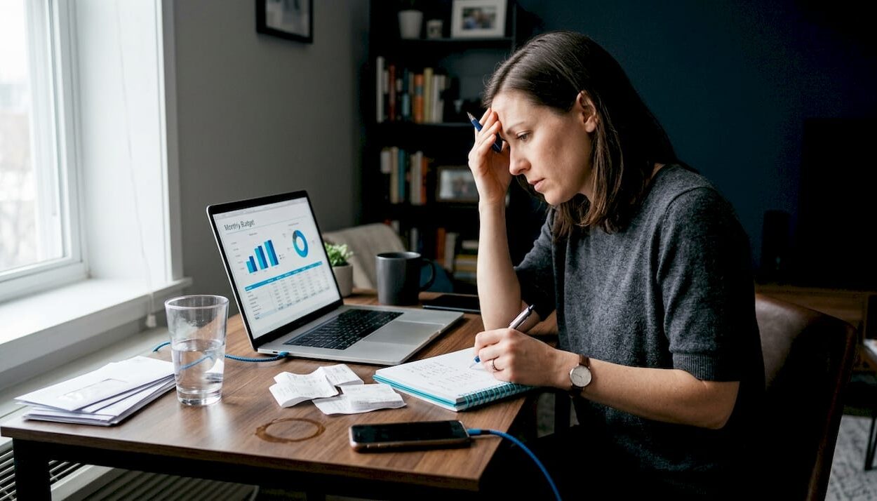 Woman reviewing finances at home desk