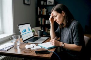 Woman reviewing finances at home desk