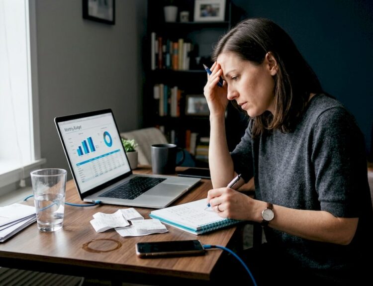 Woman reviewing finances at home desk