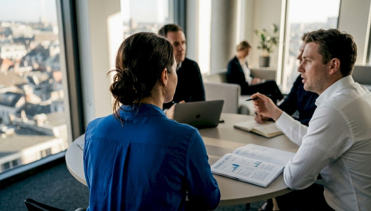Team collaborating in corner office meeting