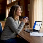 Woman considering finances at kitchen table