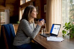 Woman considering finances at kitchen table