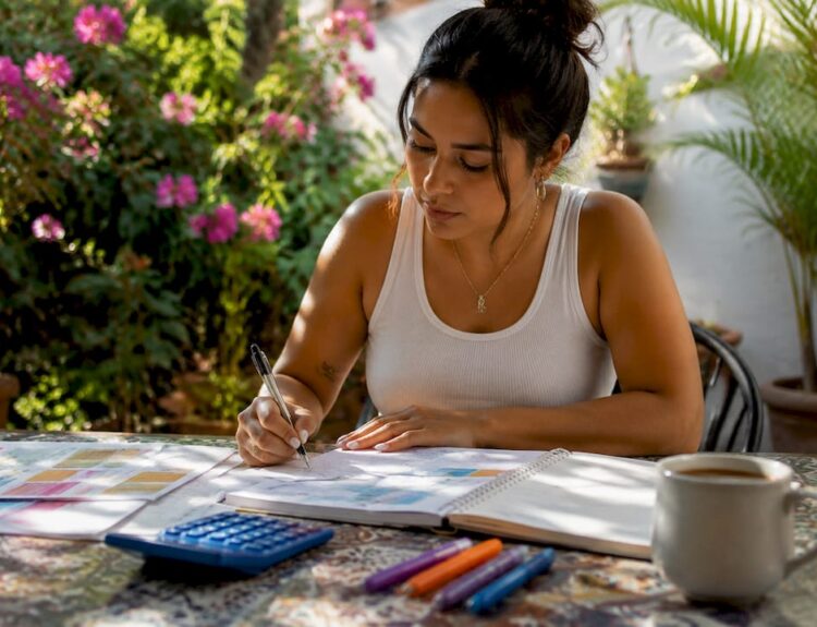 Woman reviewing debt repayment documents at kitchen table