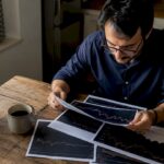 Investor studying printed stock market charts
