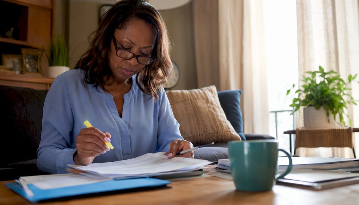 Woman reviewing IRA documents at home office table