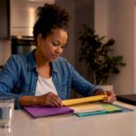 Woman organizing budget envelopes at kitchen table