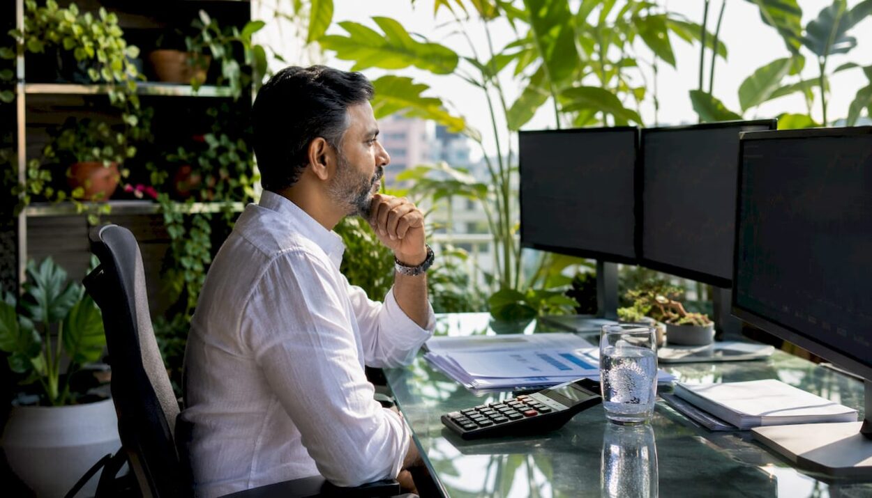 Trader monitoring currency exchange screens in office