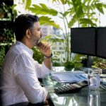 Trader monitoring currency exchange screens in office