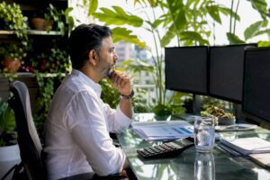 Trader monitoring currency exchange screens in office