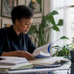 Woman reading investing books at home library desk