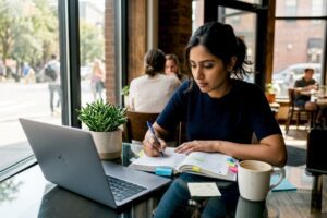 Woman studying stock market guide at home desk