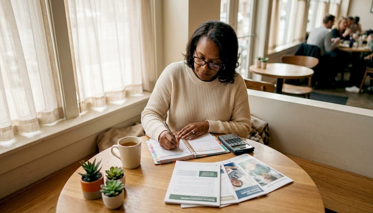 Woman reviewing personal finance documents at home desk