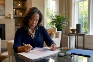 Woman reviewing estate planning documents at desk