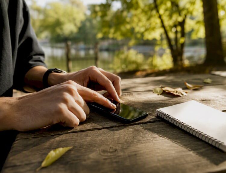 Hands setting automatic savings transfer on phone