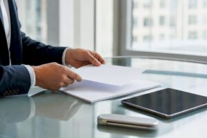 Hands arranging negotiation materials on table