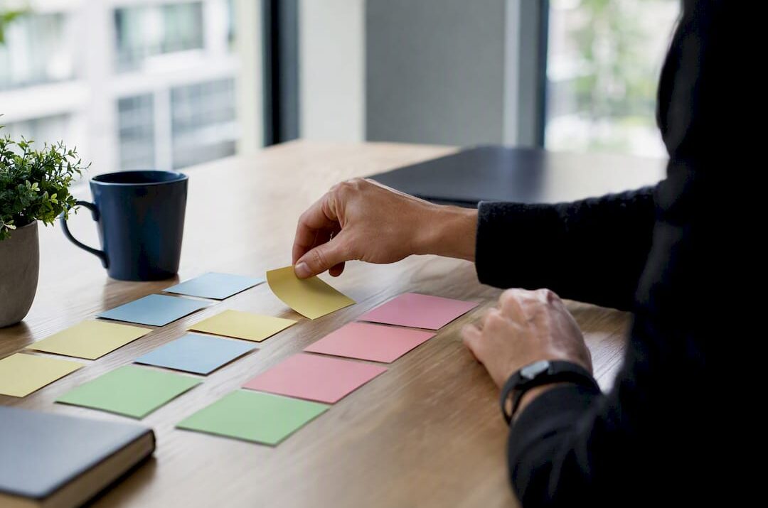 Hands arranging reasoning cards on a table