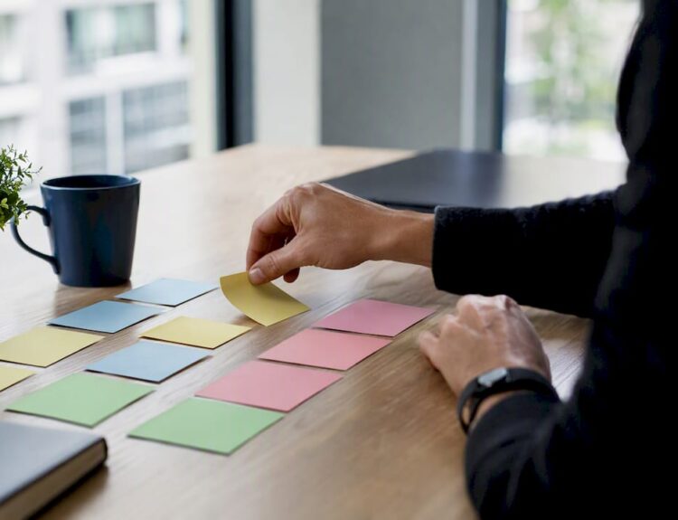Hands arranging reasoning cards on a table