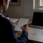 Hands holding digital notepad for meeting notes