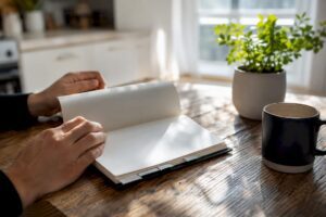 Hands flipping financial planner pages on desk