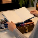 Hands layering asset protection symbols on desk