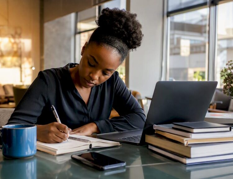 Woman planning income streams at home desk