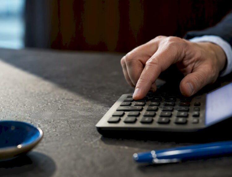 Hand entering inputs into financial calculator