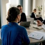 Team collaborating in corner office meeting