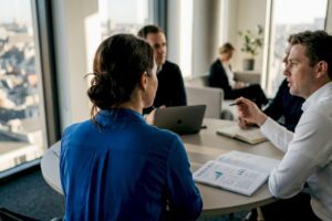 Team collaborating in corner office meeting