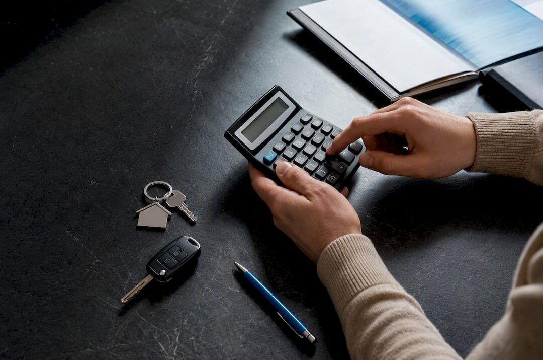 Calculator beside household asset valuation items