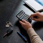 Calculator beside household asset valuation items