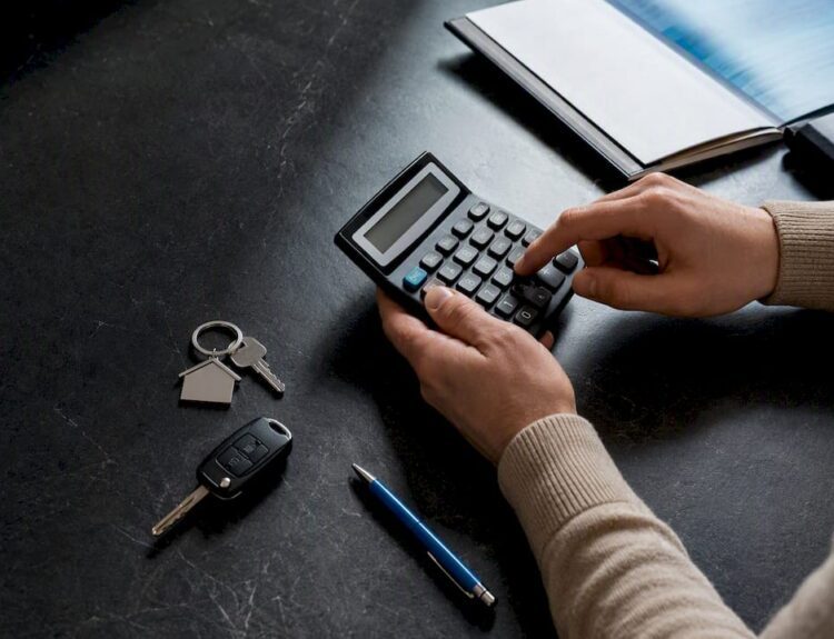 Calculator beside household asset valuation items